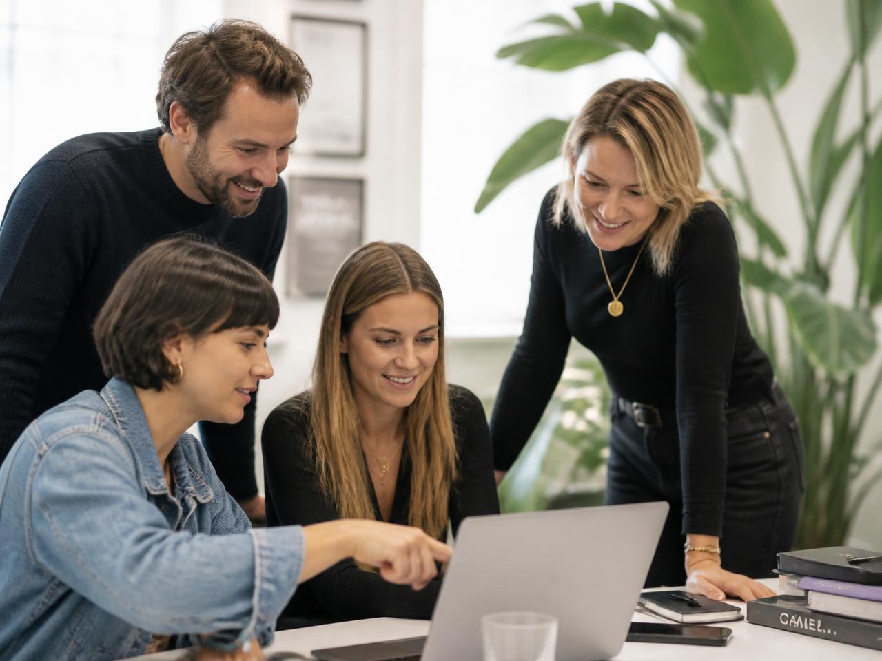 A small events team planning together around a laptop